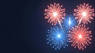 Red white and blue fireworks bursting in the dark night sky during a festive celebration