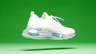 White modern sneaker rotating in mid air showcasing holographic sole design for stylish sports fashion marketing
