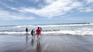 A Joyful Family Day Out at the Sunny Beach with Rolling Waves.