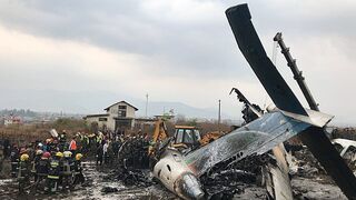 Aerial  film shows salvage teams at scene of Nepal plane accident