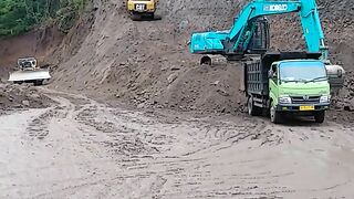 Synergy of KOBELCO SK200 and CAT 320D Excavators in Road Widening Work Loading and Hard Rock Cliff Excavation
