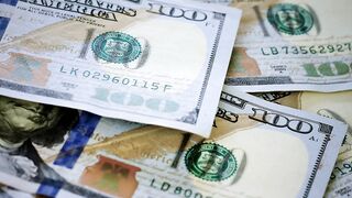 Surface while 100 dollar bills fall messily