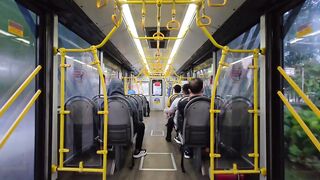 Modern Bus Interior with Yellow Handrails