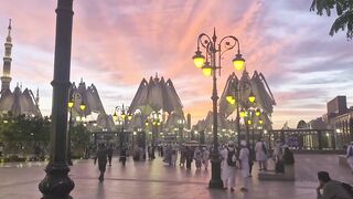 Crowd Walking in Theme Park at Sunset