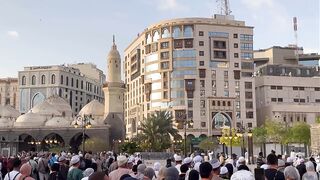 Historic Mosque with Crowd and Urban Surroundings