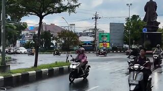 Motorcyclists Riding on Wet City Street After Rain