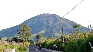 Road Leading to Mountain Under Cloudy Sky