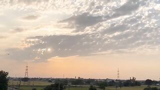 Train Passing Through Countryside at Sunset