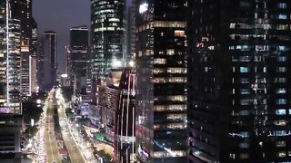Urban Night Traffic with Skyscrapers and Light Trails