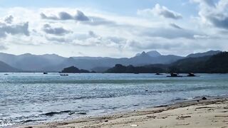 Sunny Beach and Calm Sea Under Blue Sky