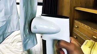 White dress shirt being steamed to remove wrinkles in an indoor setting.