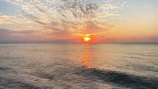 Sunrise Reflections on Calm Ocean Waves