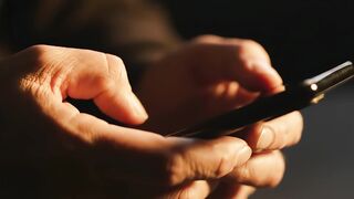 Hands using smartphone mobile device for digital communication video footage