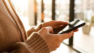 Smartphone usage motion footage showing person browsing digital media screen