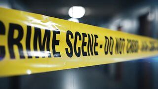 Crime scene tape barrier blocking access in dark hallway video footage