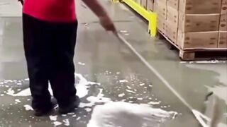 Dalam video "janitor physics" yang viral, pekerja membimbing squeegee dalam gerakan berputar yang terkontrol.