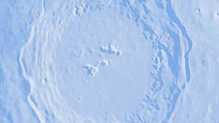 Mars peeks out from behind the moon