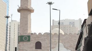 minaret in mecca with people walking | Professional HD Video
