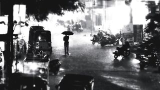 Men walking rain road