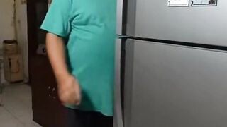 Man Looking Inside Open Refrigerator in Kitchen at Home
