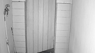 Night Vision Security Camera Footage of an Eerie Corridor with Wooden Door
