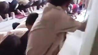 2 CHILDREN FIGHTING WHILE OTHER PEOPLE ARE PRAYING...