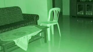 Green Night Vision Security Camera View of an Empty Living Room