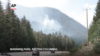 Helicopters battle a wildfire in Canada’s British Columbia
