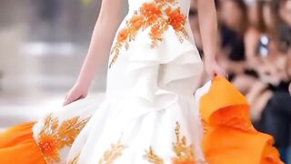 Golden Glow on the Runway: Elegance in White and Orange