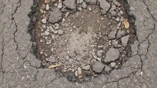 Patching the road with asphalt
