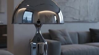 Modern chrome dome table lamp illuminating minimalist living room with soft ambient lighting