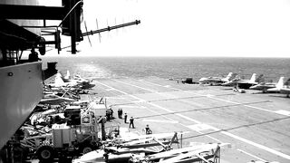 Military jet landing on Aircraft Carrier