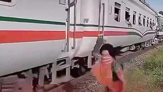 Passing Train Passenger Waves at Kid by the Tracks