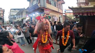Masked Man Dances on Street in South Asia