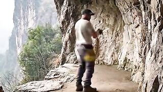 Create a hidden house behind a cliff with a natural and comfortable atmosphere.