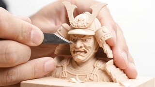 Craftsman carving wooden samurai miniature