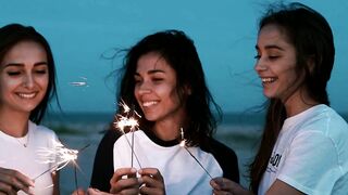 Young Women Having Fun on the Beach with Sparklers