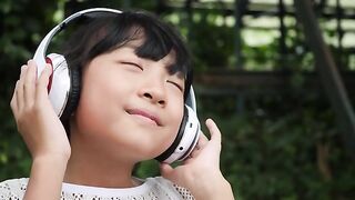 Girl listening to music on headphones and feeling good