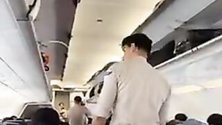 Handsome flight attendant preparing for safety briefing.mp4