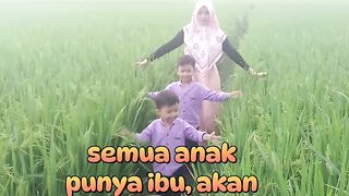 "Every child has a mother — pure love in the rice fields 💛🌾"