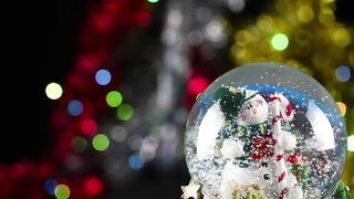 Christmas glass ball with defocused lights behind