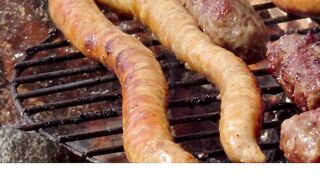 Smoked sausage and skinless sausage on the grill