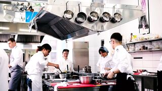 Professional chefs work in restaurant kitchen