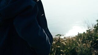 Stylish Woman Poses on the Seashore in a Trendy Denim Jacket