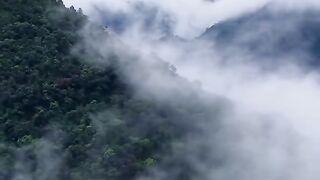 The mountain peaks covered in clouds are like a fairy tale kingdom.