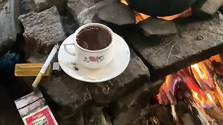 Traditional Wood-Fired Cooking with a Warm Cup of Coffee