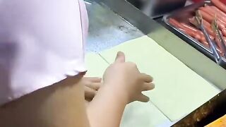 Street vendors make grilled cold noodles