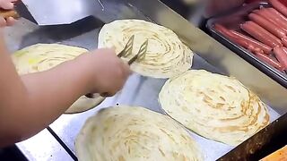 Street vendors making egg pancakes