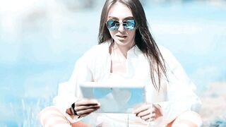 Athletic Girl Having Online Video Chat Beside Lake