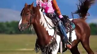 Stylish Pink Cowgirl Riding Across the Open Field
